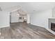 Open living room features a fireplace, hardwood floors, and seamless connection to kitchen at 16637 Brownstone Ct, Westfield, IN 46074