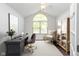 Bright office with a vaulted ceiling, large window, desk, chair, and built-in shelving unit at 16637 Brownstone Ct, Westfield, IN 46074