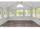 Sun-drenched sun room featuring large windows and hardwood floors, perfect for relaxation at 16637 Brownstone Ct, Westfield, IN 46074