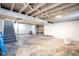 Unfinished basement with open ceiling, concrete floor and white-painted brick walls at 1725 Medford Ave, Indianapolis, IN 46222