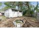 Backyard featuring a detached garage with a fire pit and grassy area at 1725 Medford Ave, Indianapolis, IN 46222