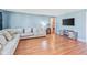 Comfortable living room features blue walls, wood floors, and an entertainment center, ideal for Gathering and guests at 1725 Medford Ave, Indianapolis, IN 46222