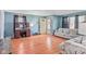 Spacious living room with light blue walls, wood floors and a large sofa, perfect for relaxing and entertaining at 1725 Medford Ave, Indianapolis, IN 46222