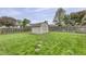Spacious backyard with green grass, a storage shed, and a stone pathway at 17752 Sanibel Cir, Westfield, IN 46062