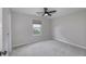 This bedroom features neutral carpet, a ceiling fan, and a window offering natural light at 17752 Sanibel Cir, Westfield, IN 46062
