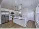 Bright kitchen features stainless steel appliances, an island with marble countertops, and wood flooring at 17752 Sanibel Cir, Westfield, IN 46062
