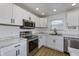 Updated kitchen with stainless steel appliances, marble countertops, and white cabinetry at 17752 Sanibel Cir, Westfield, IN 46062