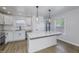 Well-lit kitchen with stainless steel appliances, marble countertops, and an island with pendant lighting at 17752 Sanibel Cir, Westfield, IN 46062