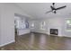 Bright living room with fireplace, wood floors, ceiling fan, and open to the kitchen at 17752 Sanibel Cir, Westfield, IN 46062