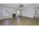 Inviting living room features a cozy fireplace, ceiling fan, and natural light from two windows at 17752 Sanibel Cir, Westfield, IN 46062