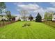A grassy backyard featuring a fire pit and plenty of room for entertaining at 19185 Rioux Grove Ct, Noblesville, IN 46062