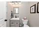 Modern half bathroom featuring a stylish vanity, decorative mirror, and neutral paint at 19185 Rioux Grove Ct, Noblesville, IN 46062