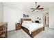 Bright and comfortable bedroom featuring a queen-size bed, ensuite furnishings, and ceiling fan at 19185 Rioux Grove Ct, Noblesville, IN 46062