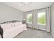 Inviting bedroom with natural light, day bed, and soft neutral tones at 19185 Rioux Grove Ct, Noblesville, IN 46062