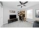 Functional bedroom with a desk, TV, and ceiling fan at 19185 Rioux Grove Ct, Noblesville, IN 46062
