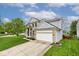 Charming two-story home with light brick, a two-car garage, and a beautifully landscaped front yard at 19185 Rioux Grove Ct, Noblesville, IN 46062