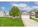 Beautifully landscaped two-story home with an attached two-car garage and a well-manicured lawn at 19185 Rioux Grove Ct, Noblesville, IN 46062