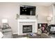 Close-up of the fireplace and mantel with decor and a large television above at 19185 Rioux Grove Ct, Noblesville, IN 46062