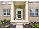 Inviting home entrance with a charming porch, brick columns, and manicured landscaping at 19185 Rioux Grove Ct, Noblesville, IN 46062