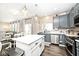 Open concept kitchen features stainless steel appliances, a central island, and hardwood floors at 19185 Rioux Grove Ct, Noblesville, IN 46062