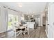 Bright eat-in kitchen with stainless steel appliances, a central island, and sliding glass door to patio at 19185 Rioux Grove Ct, Noblesville, IN 46062