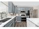 Bright eat-in kitchen with stainless steel appliances, quartz countertops, and stylish blue cabinets at 19185 Rioux Grove Ct, Noblesville, IN 46062