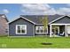 Backyard showcasing a lawn, windows, and a covered patio area at 19437 Astoria Ave, Sheridan, IN 46069