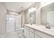 Bright bathroom featuring a double sink vanity, a shower and marble floors at 19437 Astoria Ave, Sheridan, IN 46069