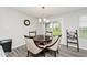 Dining room with chandelier lighting, a dark wood table, and access to the back patio at 19437 Astoria Ave, Sheridan, IN 46069