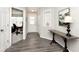 Stylish entryway with neutral walls, wood-look floors, coat closet, console table and adjacent living space at 19437 Astoria Ave, Sheridan, IN 46069