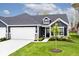Attractive home featuring dark siding, white trim, dormer window, manicured front yard and attached garage at 19437 Astoria Ave, Sheridan, IN 46069