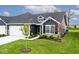 Charming home featuring dark siding, white trim, dormer window, landscaped front yard and attached garage at 19437 Astoria Ave, Sheridan, IN 46069