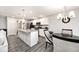 Open kitchen featuring stainless steel appliances, an island with a sink, and wood-look flooring at 19437 Astoria Ave, Sheridan, IN 46069