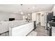 Bright kitchen boasts granite countertops, stainless steel appliances, and open layout to living room at 19437 Astoria Ave, Sheridan, IN 46069