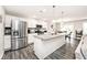 Bright kitchen with white cabinets, granite countertops, stainless steel appliances, and an island at 19437 Astoria Ave, Sheridan, IN 46069