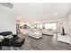 Open-concept living space with gray wood floors, neutral walls, and modern furnishings at 19437 Astoria Ave, Sheridan, IN 46069
