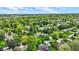 Lush neighborhood aerial shot, featuring large brick home with in-ground pool surrounded by mature trees at 195 Lake Dr, Greenwood, IN 46142