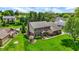 Elevated view of brick home on expansive lawn, accented by mature trees in established neighborhood at 195 Lake Dr, Greenwood, IN 46142