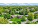 Overhead neighborhood shot with tree-lined streets, showcasing a brick home with green lawn and mature trees at 195 Lake Dr, Greenwood, IN 46142