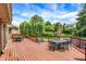 Large wooden deck with wrought iron furniture, overlooking a well-manicured backyard and in-ground swimming pool at 195 Lake Dr, Greenwood, IN 46142