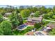 Aerial view of a backyard with a pool, a deck, and mature trees, offering a private and relaxing outdoor space at 195 Lake Dr, Greenwood, IN 46142