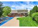 Large backyard featuring a pool, deck, lush lawn, and mature trees at 195 Lake Dr, Greenwood, IN 46142