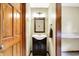 Charming powder room with a wood framed mirror, vanity and unique light fixture at 195 Lake Dr, Greenwood, IN 46142
