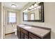 Bathroom featuring a double sink vanity with tile flooring and decorative mirror at 195 Lake Dr, Greenwood, IN 46142