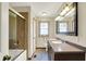 Bathroom featuring a double sink vanity, framed mirror, and a shower with glass doors at 195 Lake Dr, Greenwood, IN 46142