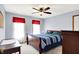 Bright bedroom with a wood bedframe, warm lighting, and natural light from the double window at 195 Lake Dr, Greenwood, IN 46142