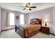 Relaxing bedroom featuring plush carpet, ceiling fan, decorative pillows, and natural light from the double window at 195 Lake Dr, Greenwood, IN 46142