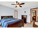 Bedroom with a wood bedframe, warm lighting, carpet, and ample storage in the matching dresser at 195 Lake Dr, Greenwood, IN 46142