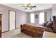 Spacious bedroom featuring a ceiling fan, plush carpet, and natural light from the double window at 195 Lake Dr, Greenwood, IN 46142