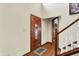 Inviting foyer featuring a decorative wood door, hardwood floors, and a staircase leading to the upper level at 195 Lake Dr, Greenwood, IN 46142